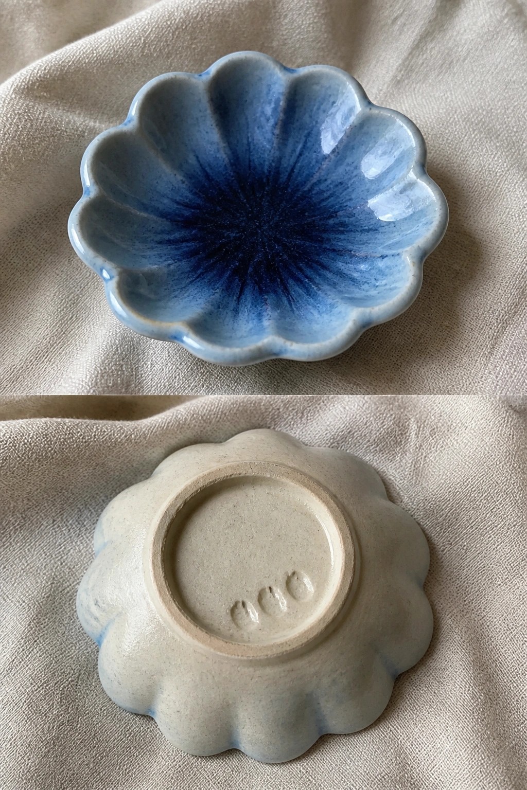 Small blue scalloped ceramic bowl, top and bottom views on beige fabric