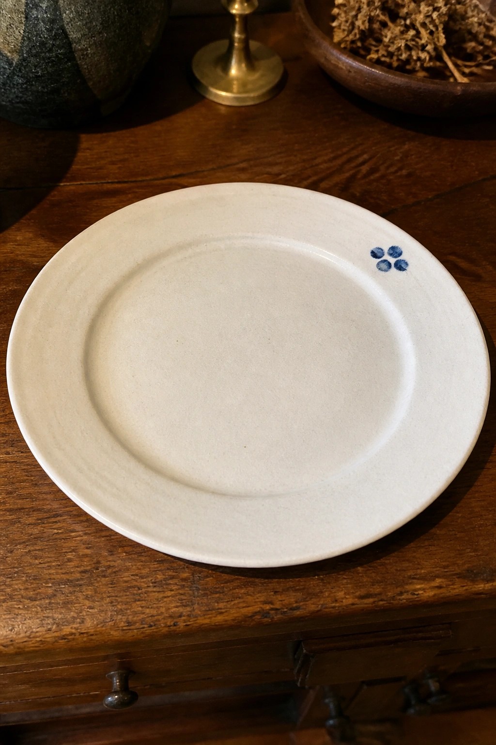 White ceramic plate with blue dot design on wooden table