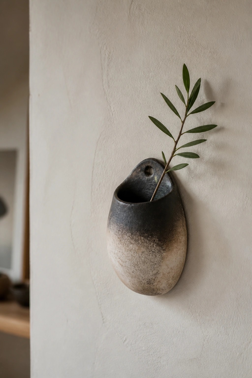 Dark ceramic wall vase fading to beige with green olive branch