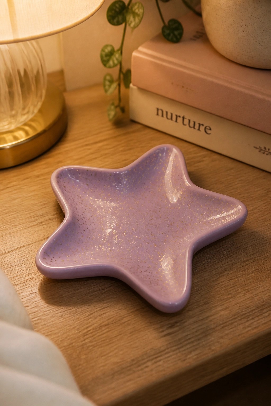 Purple star-shaped ceramic bowl with gold flecks on wooden table