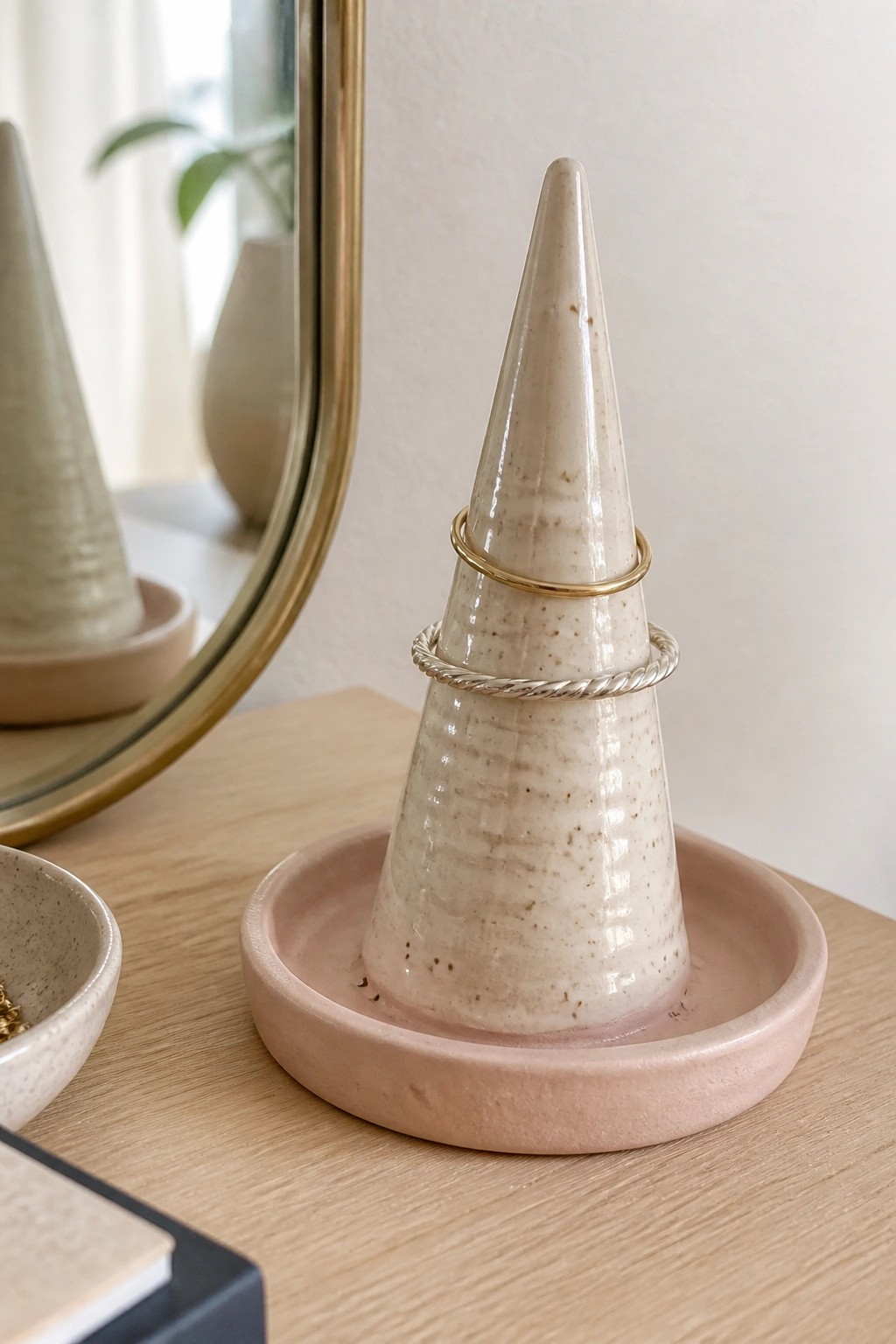 Ceramic cone ring holder with gold and silver bands on pink base
