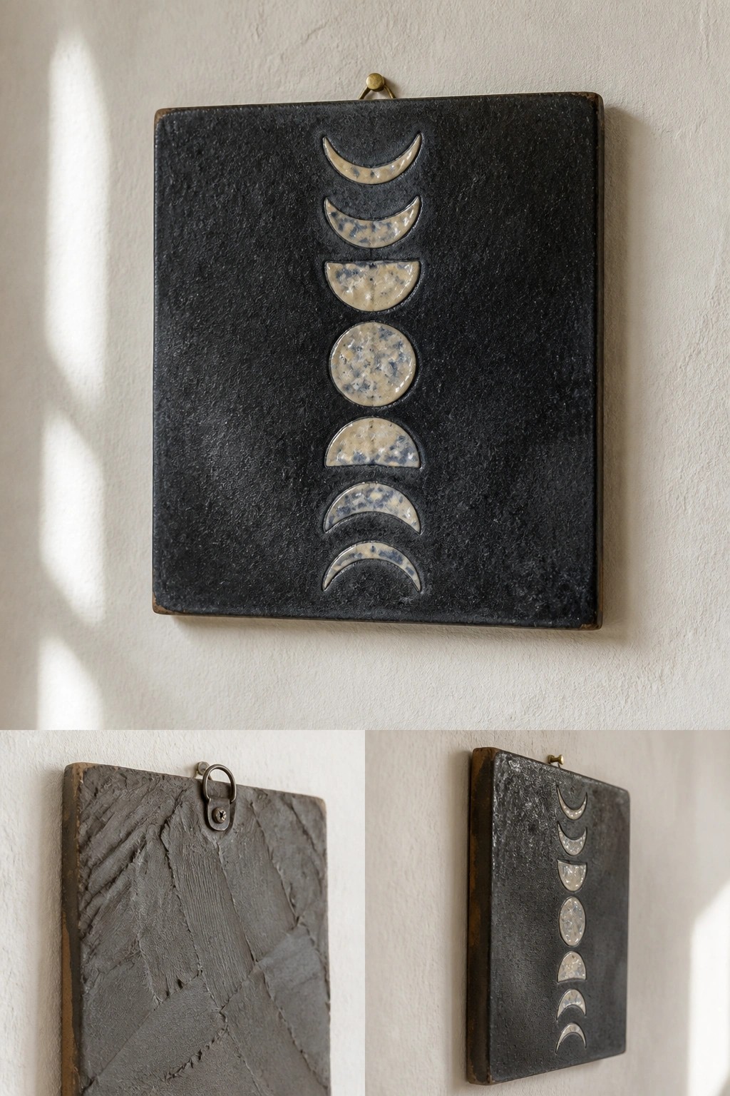 Black ceramic plaques with moon phases and gray textured tile on white wall.
